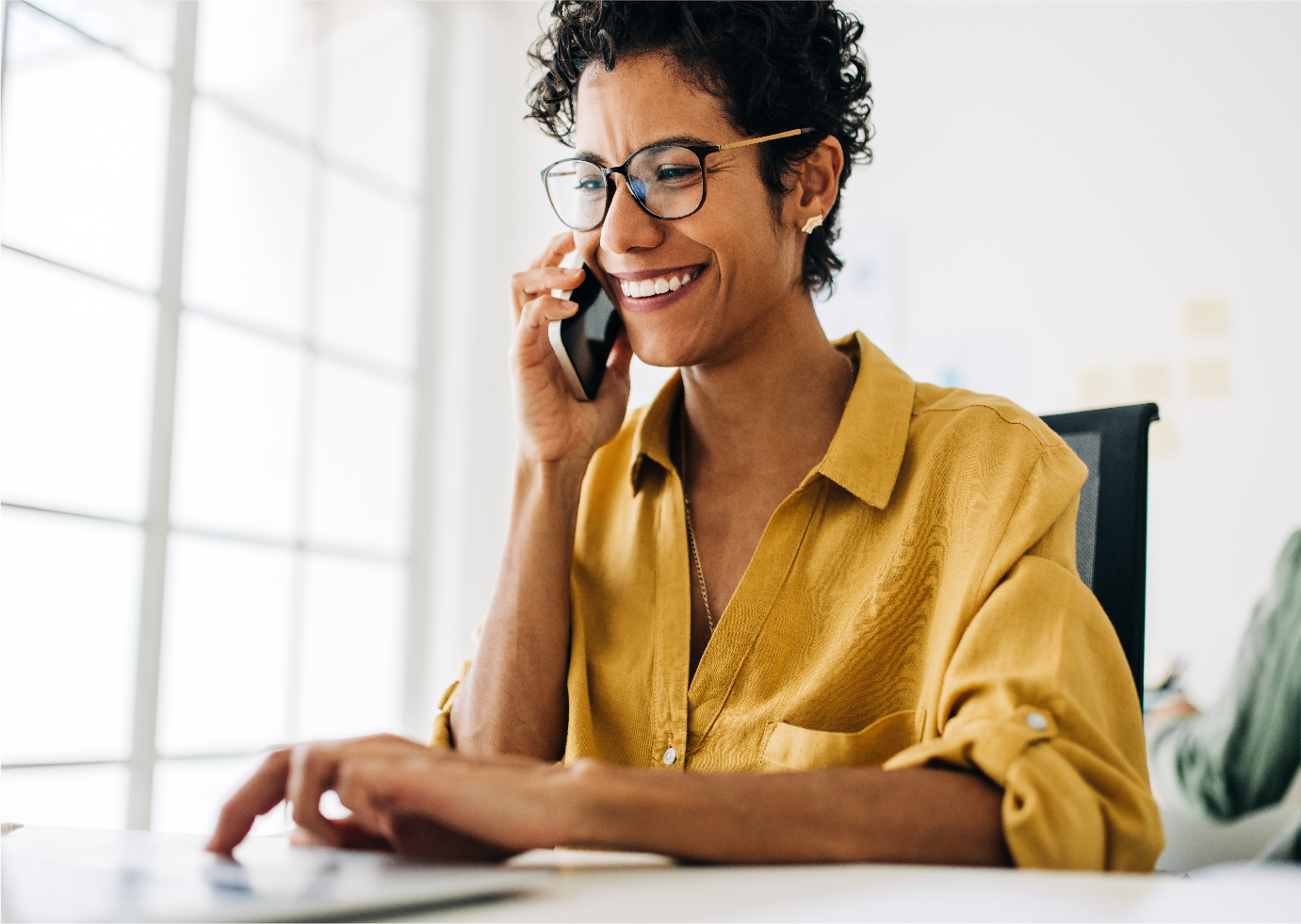 Woman wearing headphones and holding mobile phones